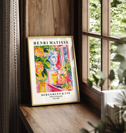 Framed wall art featuring a bust surrounded by tropical florals in vibrant tones.