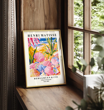 Framed art print showing seashells on sandy beach with tropical plants