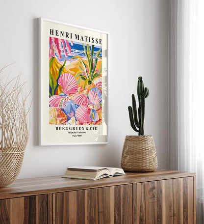 Framed art print showing seashells on sandy beach with tropical plants