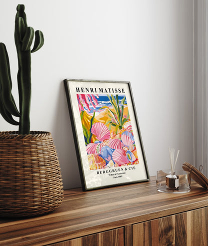 Framed coastal art print with seashells, flowers, and shoreline in bold Matisse style